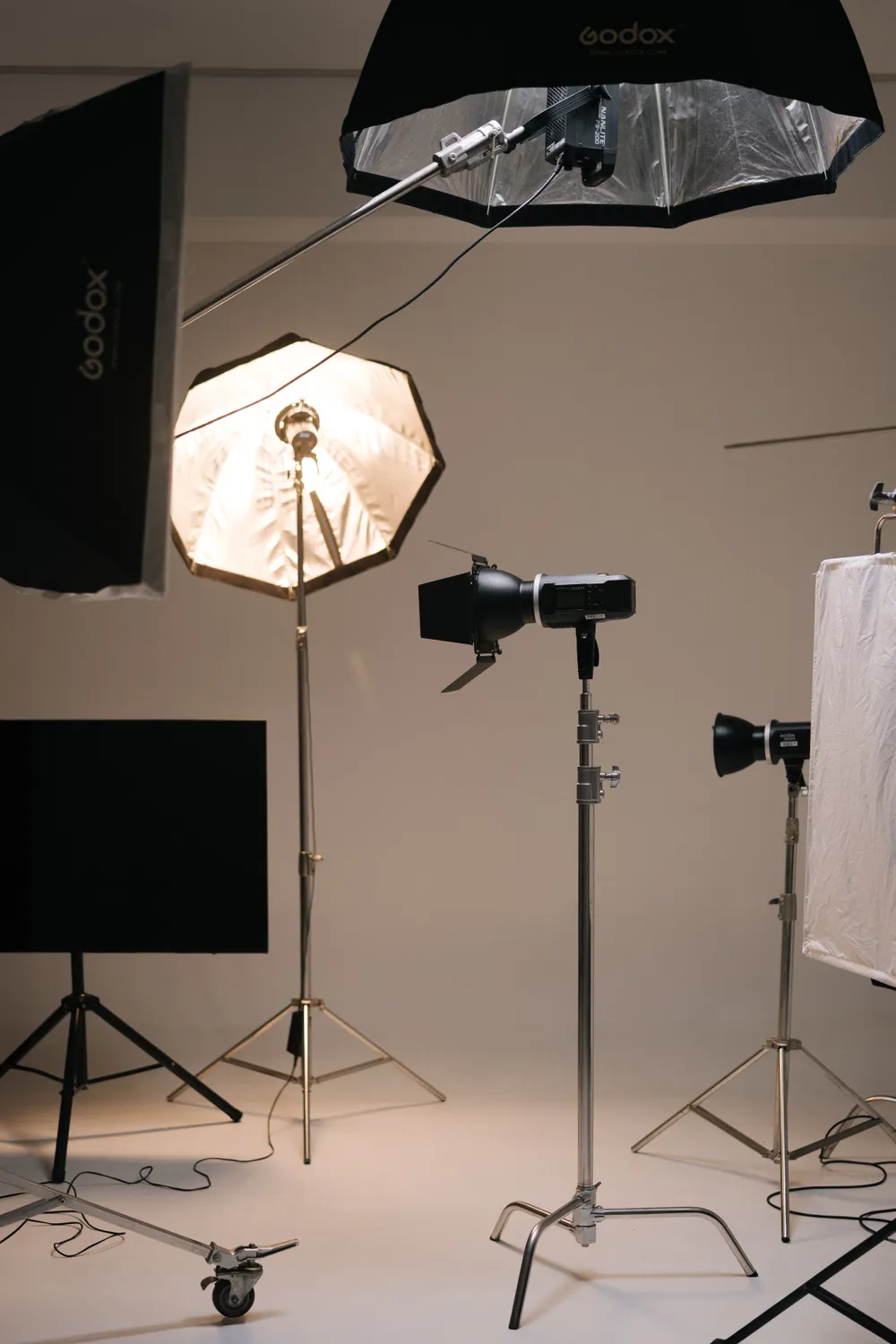 Softboxes, strobes, and tripods set up in a studio.