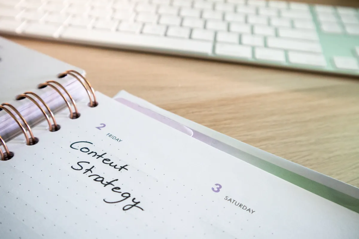 A content strategy planner open on a desk next to a keyboard.