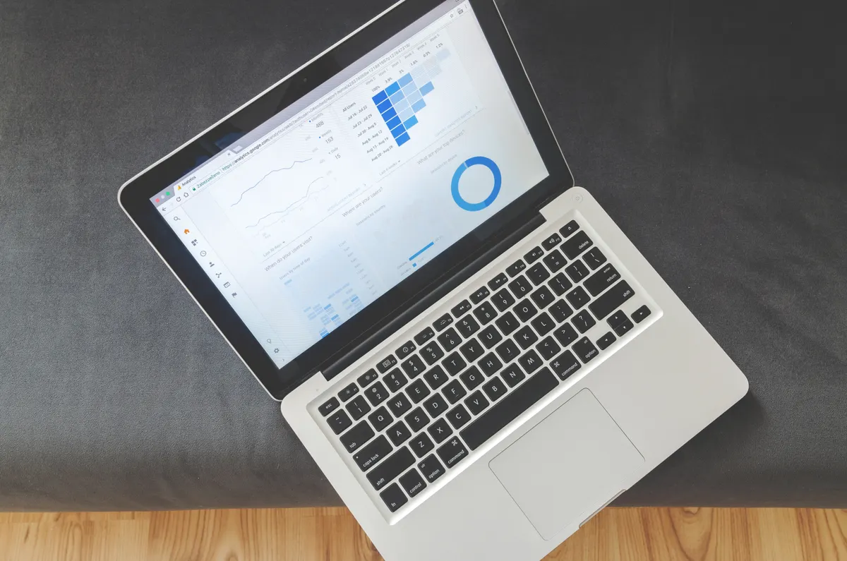 A laptop screen displaying charts and data visualisations.